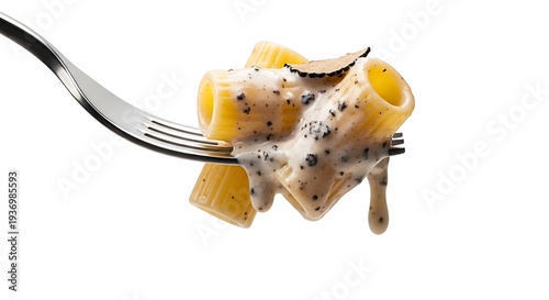 Close up of pasta with creamy sauce and truffle on a fork against white background