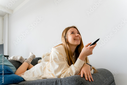 Happy Woman Watching TV Series at Home