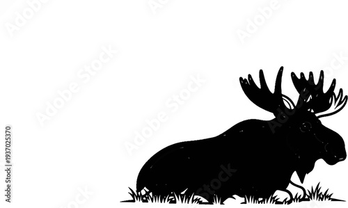 A black silhouette of a resting moose with large antlers in grass