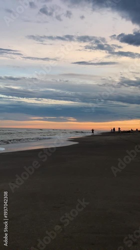 Fisherman Casting Line into Ocean at Colorful Beach Sunset