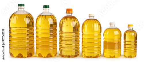 Six plastic bottles of golden oil on white background