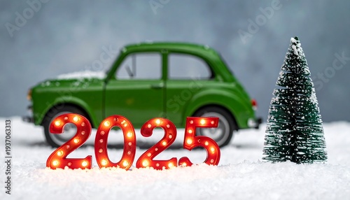 2025 lit number props with vintage green toy car and pine tree on snowy surface against a blurred grey background