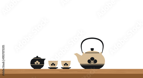 Japanese-style beige and black tea set with floral motif on wooden surface.