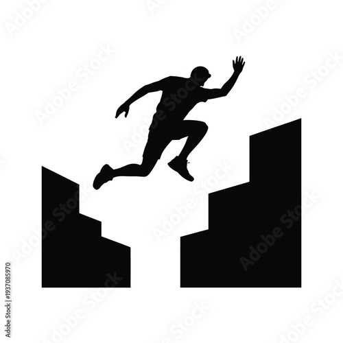 Silhouette of a person leaping across a gap between two structures