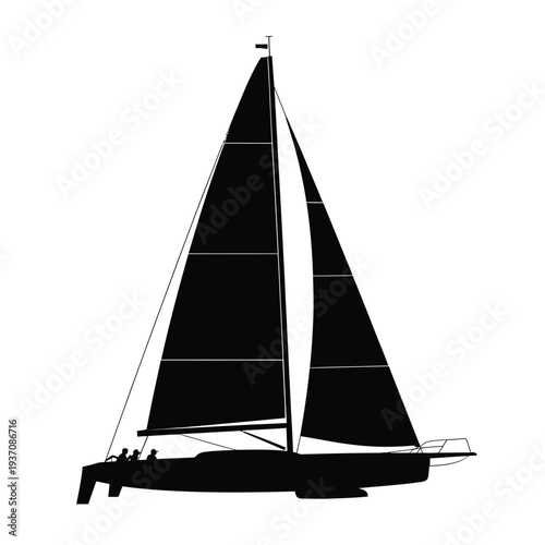 Sleek silhouette of a modern sailboat with raised sails at sea