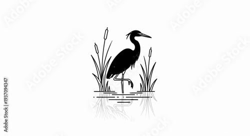 Silhouette of a heron standing in water with reeds and reflection