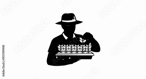 Silhouette of a person in a hat tending to a tray of seedlings