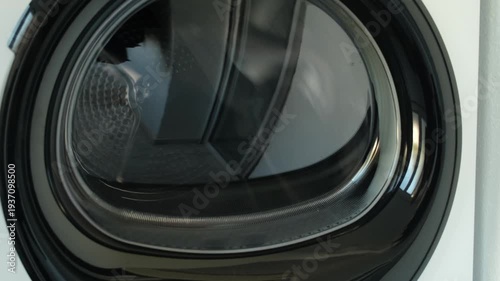 Clothes drying in the dryer while it spins.