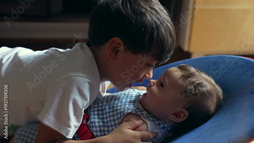 Cuadro en lienzo Young boy gently touching baby sibling’s nose, soft bonding moment, brotherly lo
