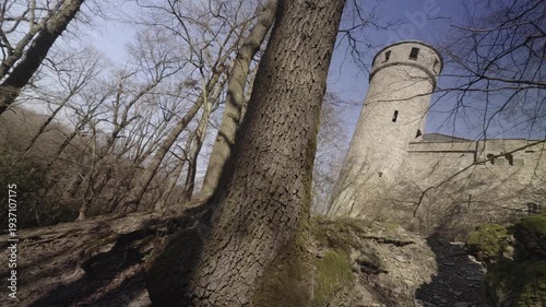 Ancient Stone Watchtower Framed by Spring Trees
