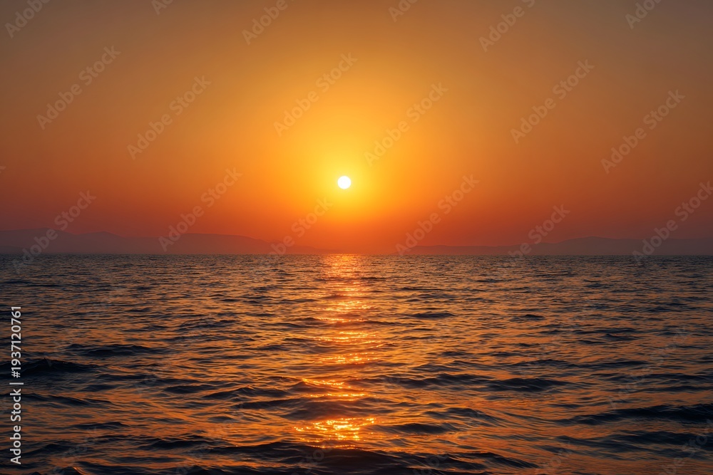 Fototapeta premium The sun setting over the tranquil ocean, casting a warm glow