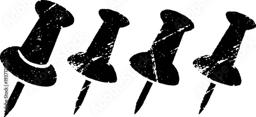 Four black push pins isolated on white background in grunge
