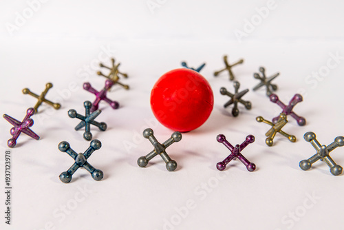 Canvastavla colored metal jacks with red rubber ball on white background