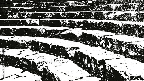 Ancient stone steps with weathered cracks and rough texture in monochrome black and white