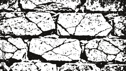 Black and white cracked stone wall texture with irregular shapes and rough surface pattern