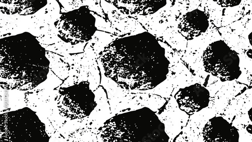 cracked dry earth pattern with irregular dark soil patches in arid landscape