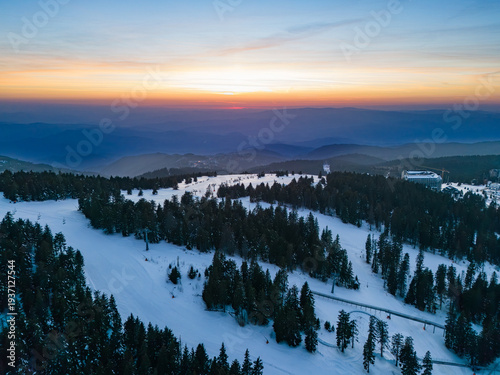 Beautiful winter sunset over the snowy landscape of Kopaonik in Raka District Serbia on a clear evening