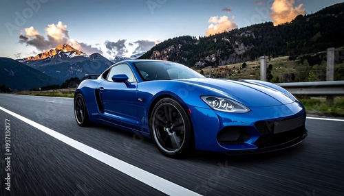 A blue coupe races down the road, mountains & sunsetting sky backdrop the scene in this dramatic, sleek, automotive shot