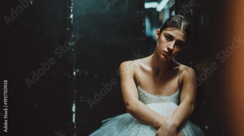 Young Ballerina Sitting Pensively Backstage in a Dimly Lit Theater Dressing Room After Performance
