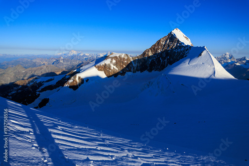 Mountain glacier panorama with summit Lyskamm (foreground right) and Mont Blanc massif (background left) in Pennine Alps, Italy