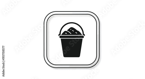 Black bucket filled with sand presented as a stark silhouette