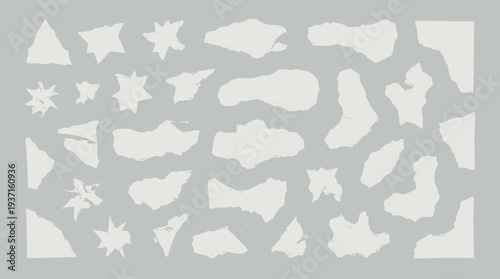 Collection of assorted white abstract shapes on gray background.