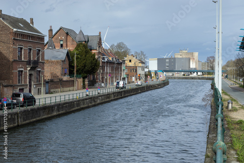 View of the Brussels-Charleroi canal as it passes through the city of Halle, in Flemish Brabant, Belgium. The canal is part of a north–south axis of water transport in Belgium. Copy space above.