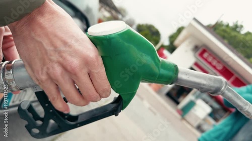 Expensive Gasoline Fuel Nozzle Filling a Car