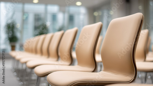Row of modern beige chairs in a bright waiting room, minimalist interior design with copy space.