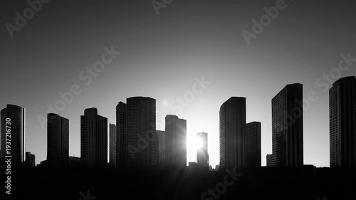 Silhouette of Modern City Skyscrapers Against Dramatic Sunlight with Black and White.