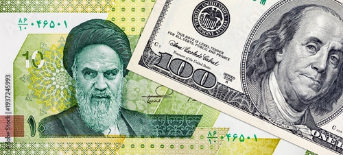 US Dollar and Iranian Rial Banknotes with portraits of Benjamin Franklin and Ruhollah Khomeini. War between the United States and Iran.