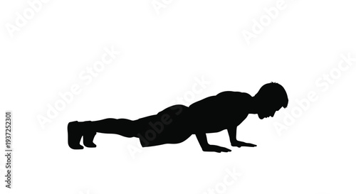 Man performing a push up exercise in a dark striking silhouette