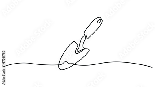 A trowel is digging into the ground