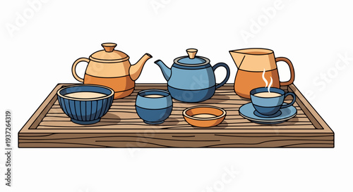 Tea service set with teapots pitcher cups and bowl on wooden tray