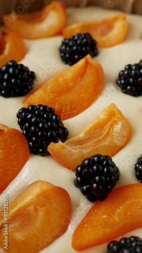 Close-Up of fresh apricot and blackberry topping on homemade berry pie ready for baking.