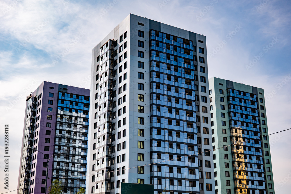Fototapeta premium Modern residential towers soaring against urban sky, symbolizing city living and development
