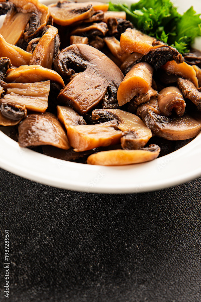 Fototapeta premium Champignon mushrooms ready to eat tasty snack fresh gourmet food background on the table rustic food top view copy space keto and paleo diet vegetarian and vegan food marketing concept photo