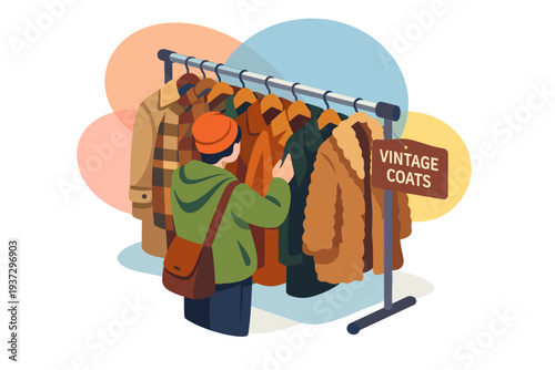 Person browsing vintage coats on a rack at a market stall.