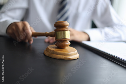 Lawyer Reviewing Contract and Documents with Gavel on Desk.
