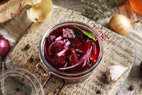 Homemade fermented beet kvass in a glass jar from fresh beetroot, onions, garlic and spices