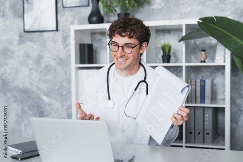 Online medical consultation. Confident male doctor family therapist sit by laptop talk to patient via telehealth videocall explain diagnosis give recommendations remotely from clinic office