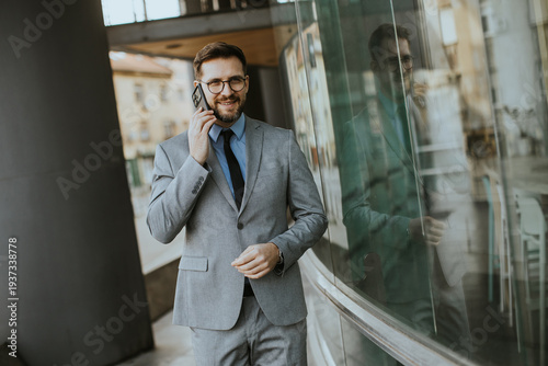 Businessman talks on phone ...