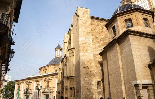 Valencia Cathedral and Royal Basilica of Our Lady of the Forsaken (Real Basílica de Nuestra Señora de los Desamparados) from Plaza de la Virgen, Valencia, Spain. 