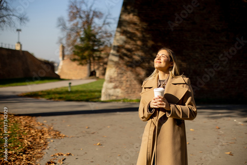 Woman enjoys coffee while s...