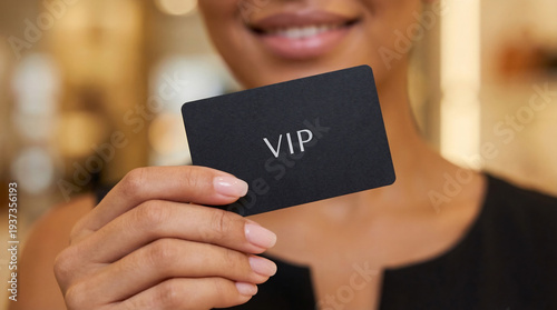 Young woman smiling while holding VIP card indoors with soft light  