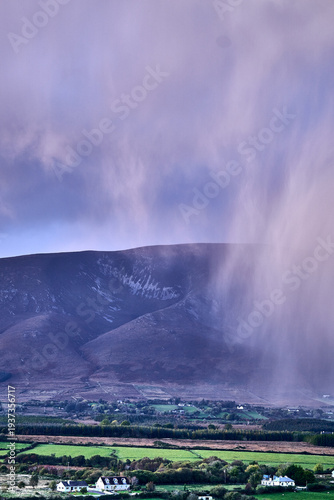 Aerial view of dramatic evening storm clouds at stunning evening in Ireland Co.Mayo, pouring rain beside mountain