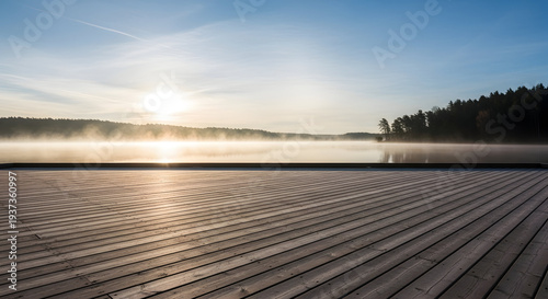 Serene sunrise over a misty lake with a wooden pier in the foreground, casting long shadows and reflecting the golden light of dawn.