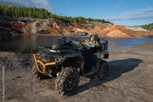 Modern Assault Rifle and Tactical Gear on ATV in Outdoor Terrain