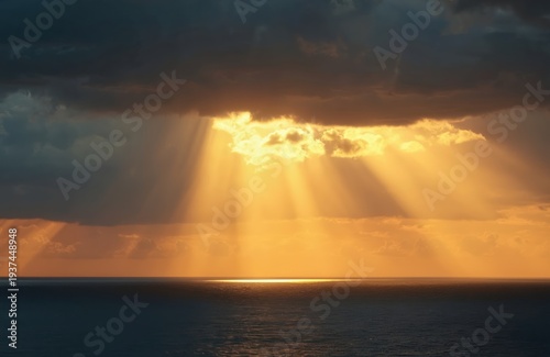 Sun rays pierce dark clouds over calm ocean surface. Golden light reflects on water at dusk. Sky shows dramatic cloudscape and peaceful natural scene.