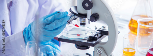 Banner Asian woman scientist hand write note research in medical lab look at science microscope. Asian Female technician laboratory using microscope with copy space. Banner Scientist chemistry